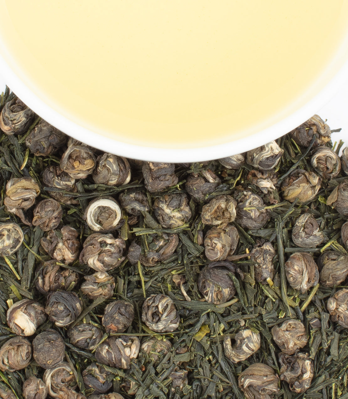 Dried green tea leaves and brewed green tea in a white cup, showcasing Angiogenesis Foundation Green Tea.