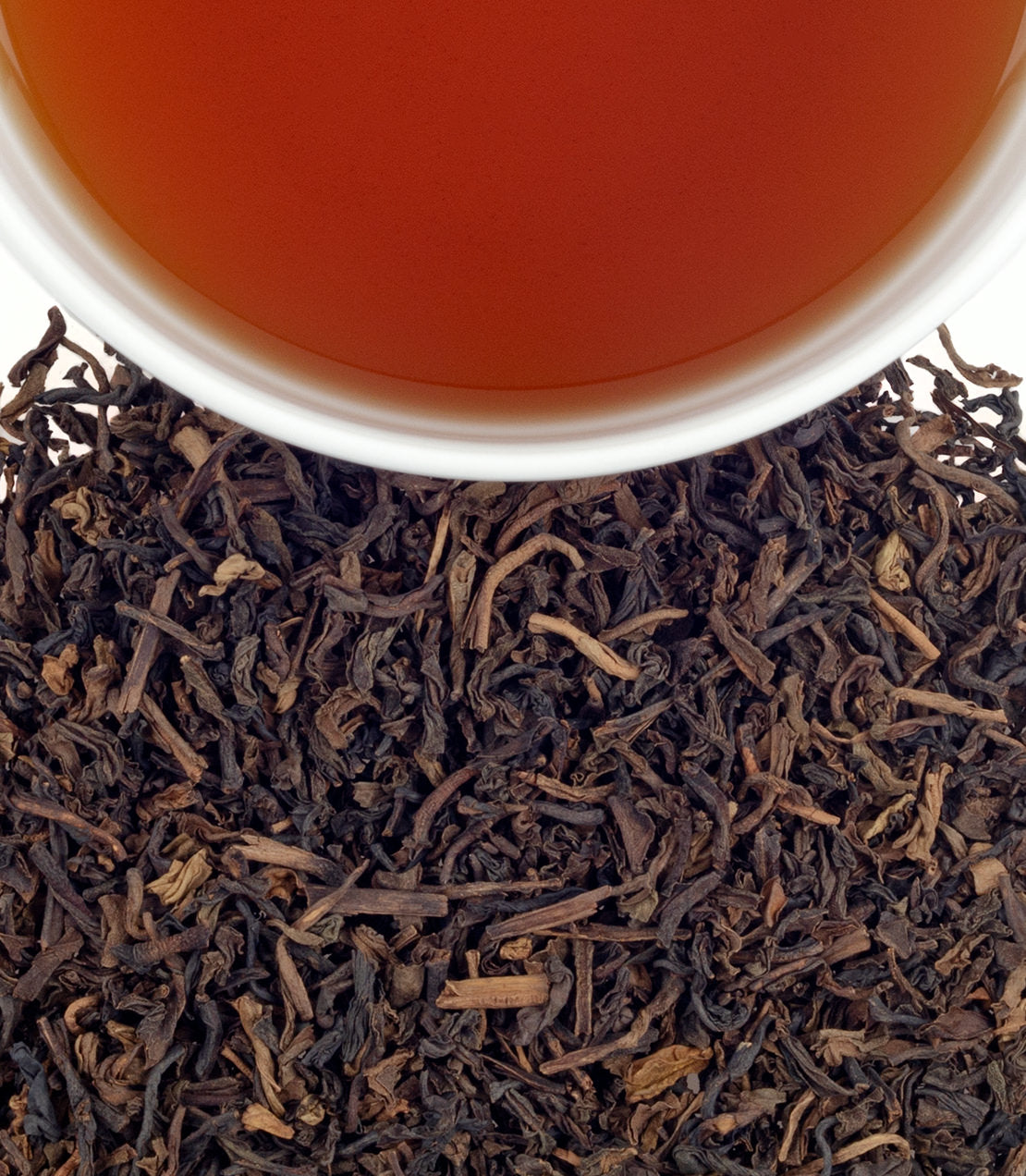 Harney & Sons Fine Teas- Vanilla Bean- Overhead photo of dry leaves pictured below cup of brewed tea