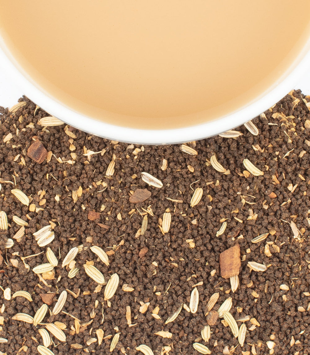 Heartland Masala Chai Tea and cookbook bundle featuring loose tea blend with spices and a cup of brewed chai.