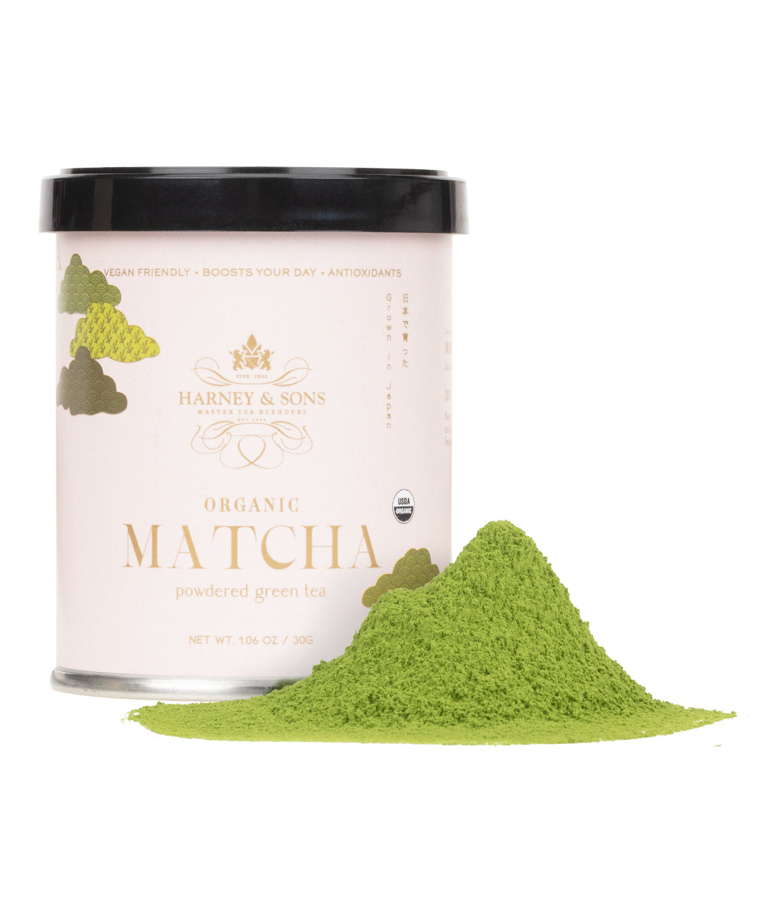 A pink 30 gram container of organic matcha powder with a small pile of green matcha powder spilled beside it.